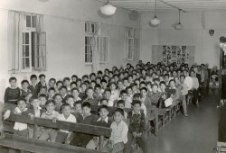 Like most Nuu-chah-nulth-aht of their generation, Charlie Cootes and Robert Dennis attended residential school. Pictured is the boys section of the assembly hall of the Alberni Indian Residential School in the 1960s, where Cootes and Dennis attended. (United Church of Canada archives)