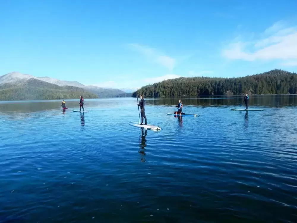 Natasha Charleson stand-up paddle boards in Grice Bay, near Tofino, as part of the Indigenous Ecotourism Training Program. (Photo suppled by Natasha Charleson)