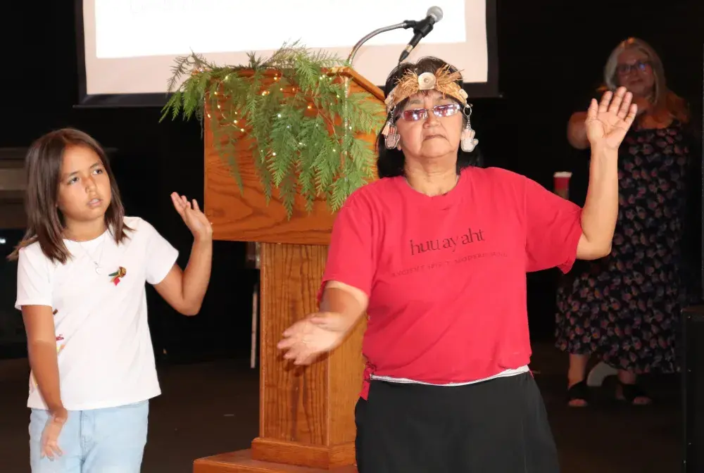 Huu-ay-aht dancers, including Colleen Peters in red, dance in celebration of Oomiiqsu Centre, which will open in the coming weeks.