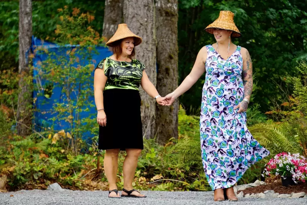 Naomi Nicholson and Nicole Malcomson wearing outfits from Ay Lelum- The Good House of Design during a fashion show at the Chims Guest House grand opening event on Aug. 7. 