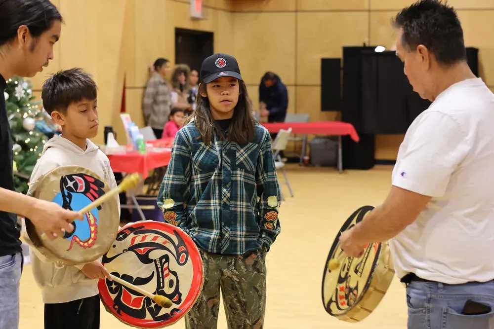 Quaya Sam leads a young group of traditional drummers.
