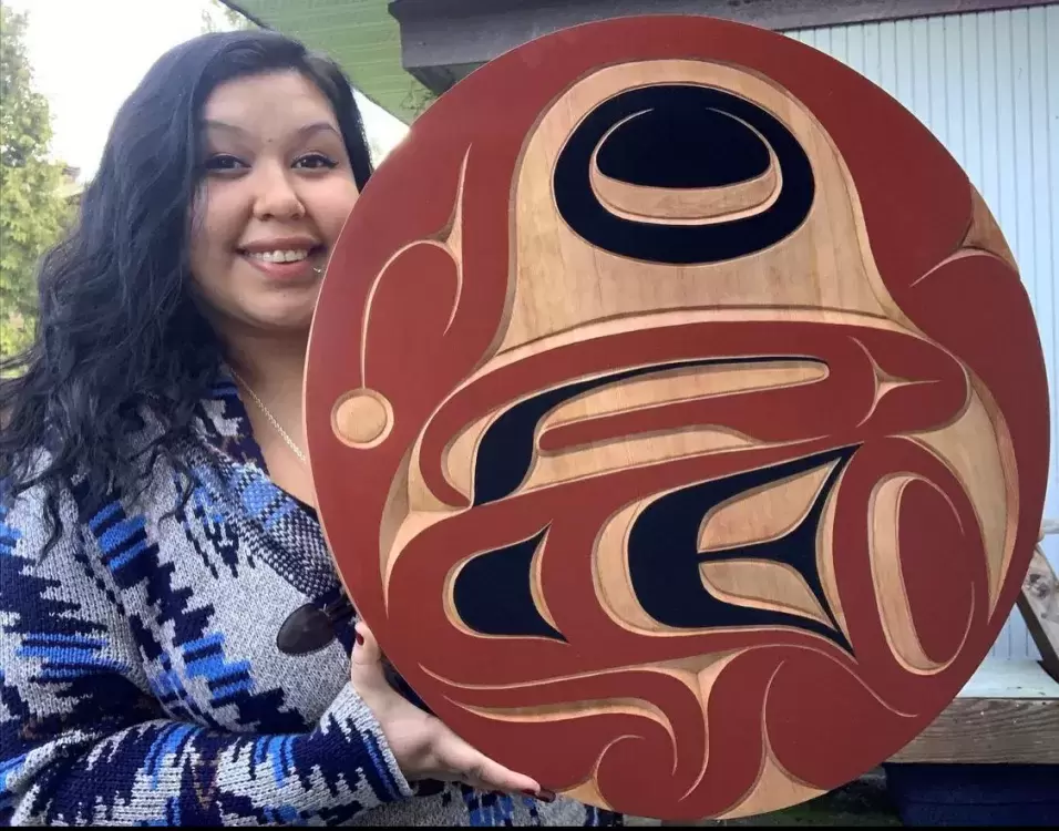 Pictured is Williams with a red cedar eagle panel carving. 