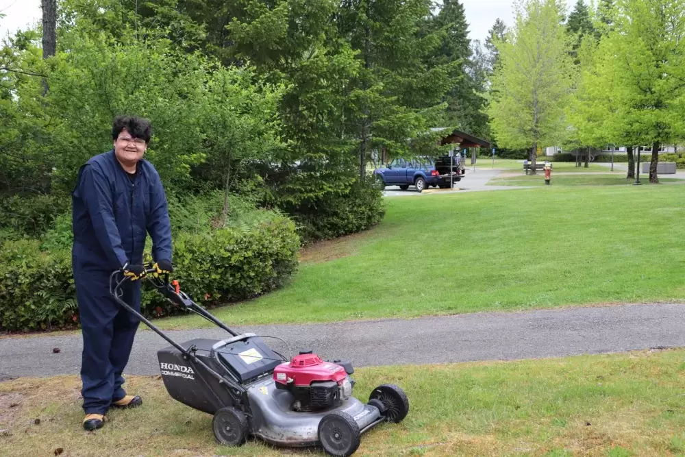 Gary Peter mows the grass at North Island College, part of his work in the Employment Transition Grounds & Custodial Assistant Program offered through the college’s Department of Accessible Learning Services (DALS). 
