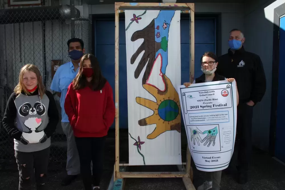 Under the concept that nature and people are one, while everyone is connected through the natural world, a poster made by Grade 5 and 6 students was chosen to promote the First Nations Spring Festival. Pictured from left to right are Azlynn Keinas, Samantha Blakey and Kyra Papove, with Richard Samuel, a cultural development supervisor with the Nuu-chah-nulth Tribal Council, and A.W. Neill Principal Darrin Olson.