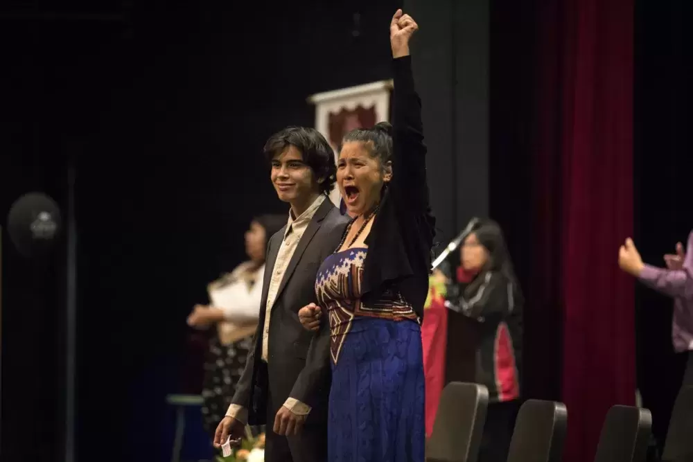 Tyson Whitford-Williams (left) is cheered for while walking the stage at the Nuu-chah-nulth Tribal Council Graduation ceremony held at the Alberni District Secondary School in Port Alberni, on June 11, 2022.