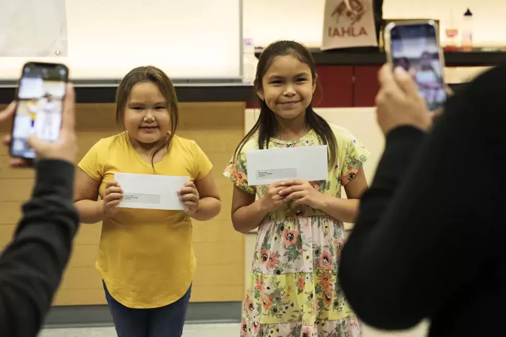 Jade Thomas (left) and Nevaeh Atleo pose with their scholarship cheques during Nuu-chah-nulth Tribal Council Scholarship Ceremony held at the Alberni District Secondary School in Port Alberni, on June 10, 2022.