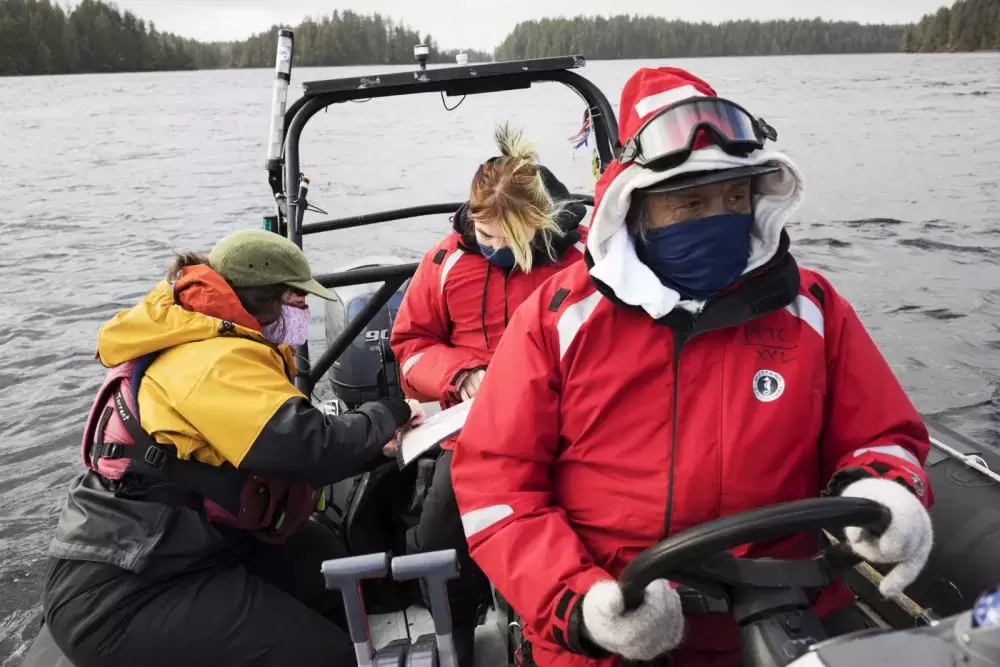 Datum Marine instructor, Marla Barker (left), helps Brianna Lambert navigate while Joe Titian drives the boat during the Captain's Boat Camp, near Tofino, on Feb. 22 2021. Photograph by Melissa Renwick