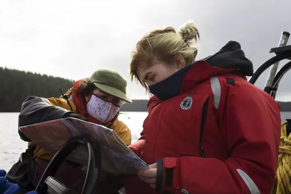 Datum Marine instructor, Marla Barker (left), helps Brianna Lambert navigate a boat during the Captain's Boat Camp, near Tofino, on Feb. 22 2021. Photograph by Melissa Renwick
