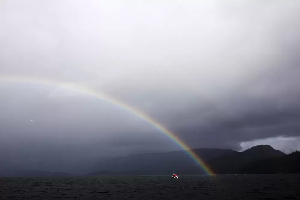 A rainbow emerges from the water during practical training as part of the Captain's Boat Camp, near Tofino, on Feb. 22 2021. Photograph by Melissa Renwick