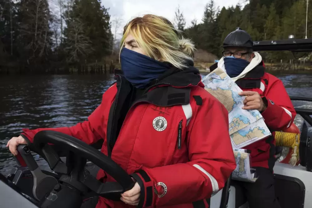 Brianna Lambert drives the boat back to Tofino while Joe Titian navigates during the Captain's Boat Camp, on Feb. 22 2021. Photograph by Melissa Renwick