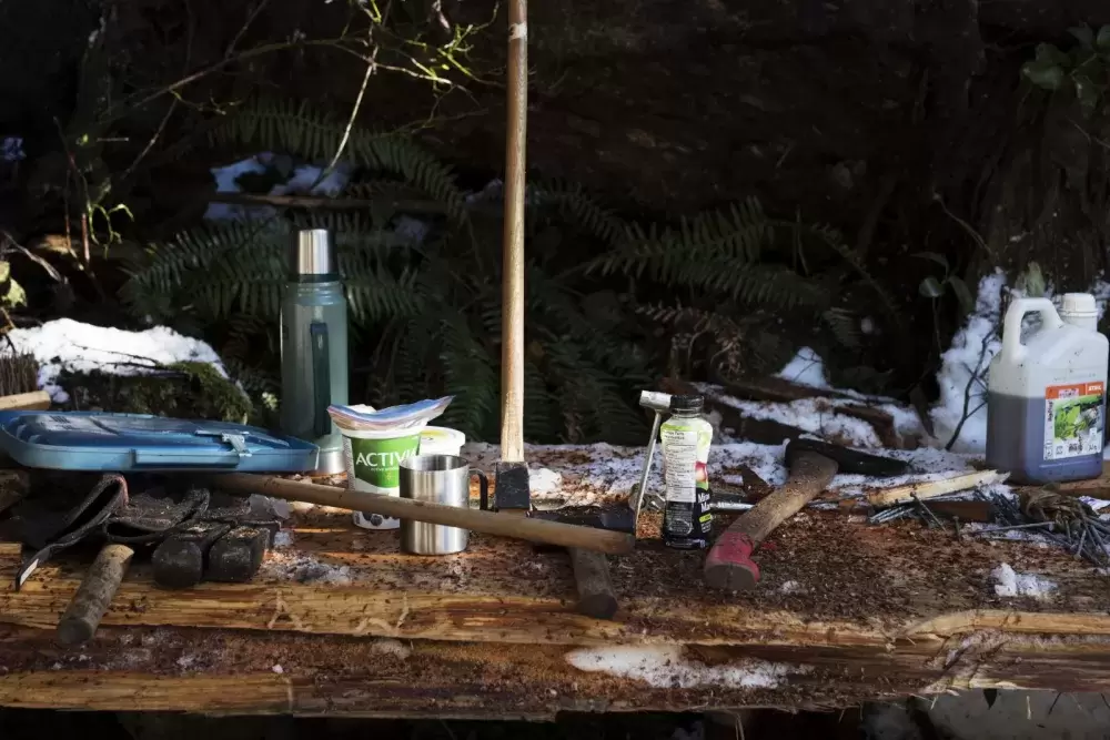 Tools are strewn out over a makeshift shelf in the forest, on Feb. 16, 2021. 