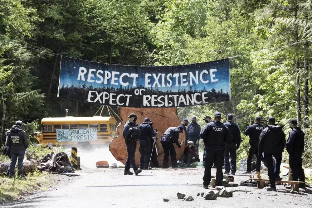 RCMP arrest a protestor who goes by Machin at the Caycuse old-growth logging blockade, which was established by the Rainforest Flying Squad, near Port Renfrew, on May 19, 2021.