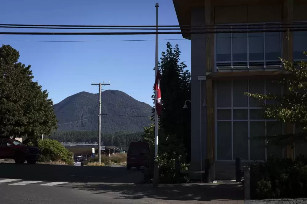 The Canadian flag flies at half-mast in front of the Tofino RCMP detachment, on September 2. (Melissa Renwick photo)