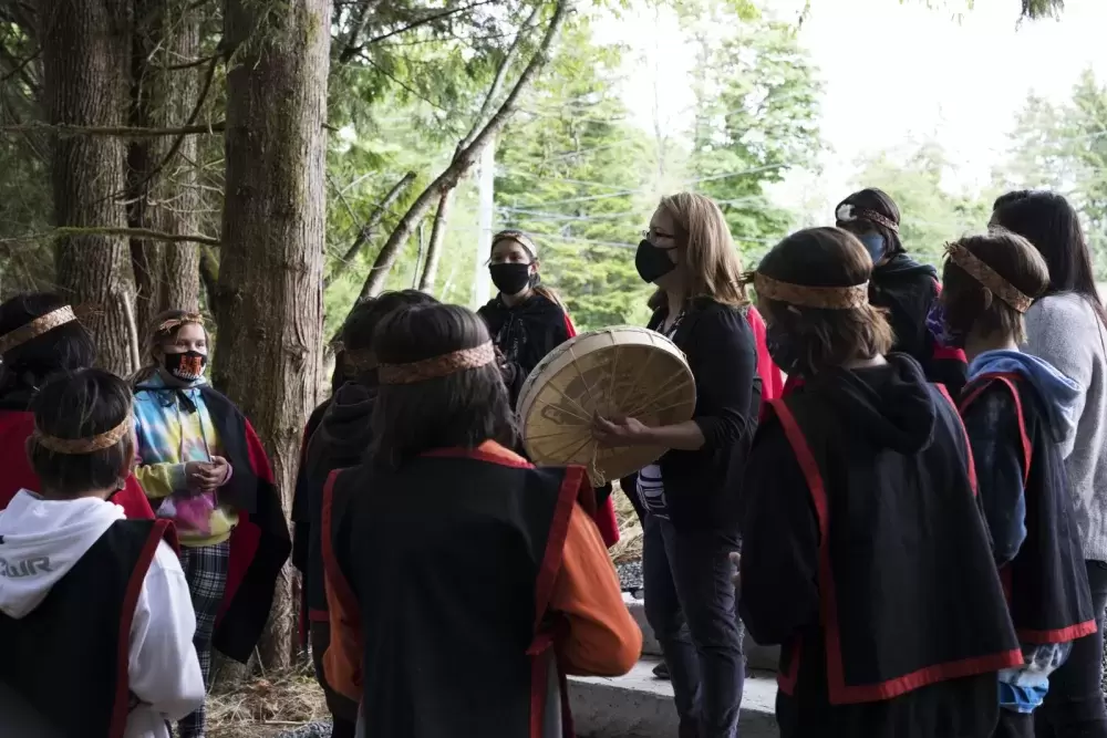 Helen Lucas (centre) and her Grade 5/6 class at Haahuupayak Elementary School sing together before the blessing ceremony of the school's new outdoor learning space, on June 11, 2021.