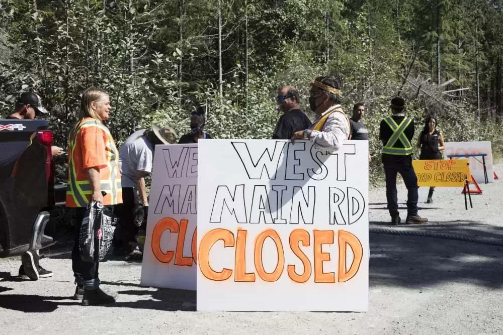 Supporters help to decorate West Main Forest Service Road with road closure signs, near Tofino, on August 10, 2021. 