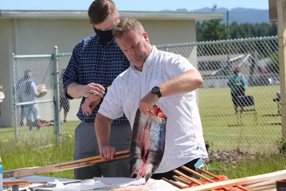 David Maher, principal of the Eighth Avenue Learning Centre, prepares salmon for a traditional barbeque.