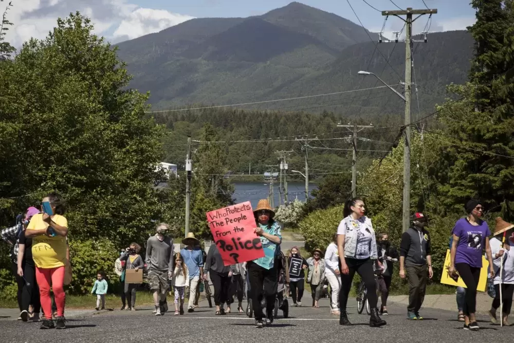 A protest marches through Ucluelet in June 2020, after Chantel Moore was fatally shot by a police officer in Edmunston, New Brunswick that spring. A new report from the BC Office of the Human Rights Commissioner is calling for funding to be redirected from police towards social services better suited to respond to mental health crises. (Melissa Renwick photo)