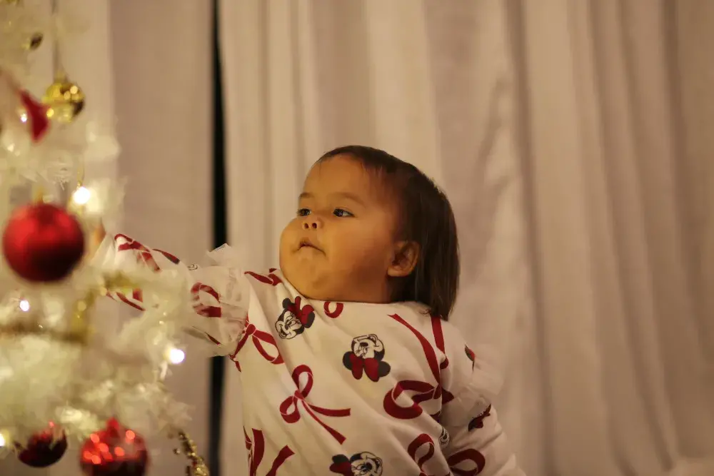 Savannah Joseph-Frank inspects the Christmas tree.