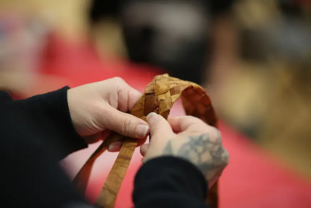 Mowachaht's Crystal Howard weaves cedar.