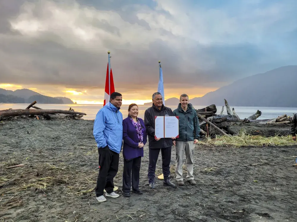 Gary Anandasangaree (left), minister of Crown-Indigenous Relations, Ditidaht Chief Councillor Judi Thomas,  Pacheedaht Chief Councillor Jeff Jones, and Dave Tovell, Parks Canada's acting field unit superintendent for coastal B.C., signed an agreement to return the use of ?A:?b?e:?s, Middle Beach, to Pacheedaht First Nation near Port Renfrew on Nov. 15. (Parks Canada photo)