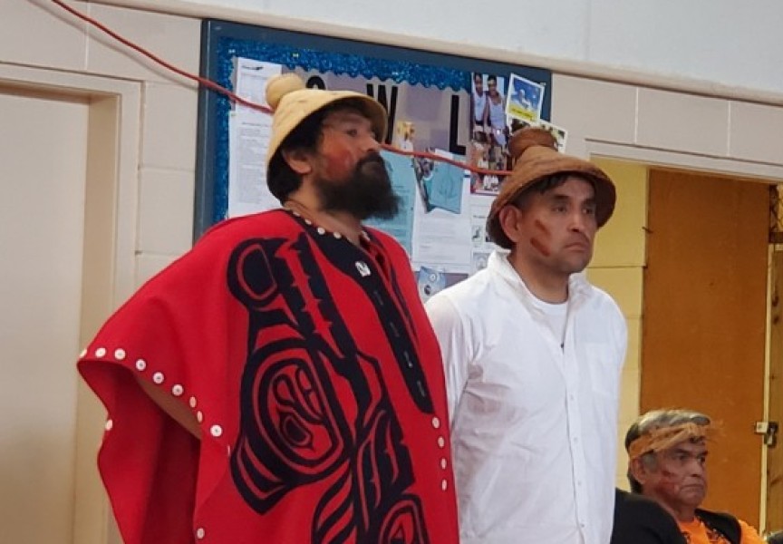 Ahousaht Ha’wiih Hasheukumiss (Richard George, standing in for his father Maquinna, Lewis George) and Hanuquii (Nate Charlie) are trying to stop bootlegging in their home community. (Denise Titian photo)