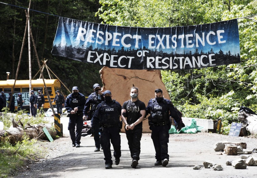 A protestor is arrested at the Caycuse old-growth logging blockade established by the Rainforest Flying Squad, near Port Renfrew, on May 19, 2021.