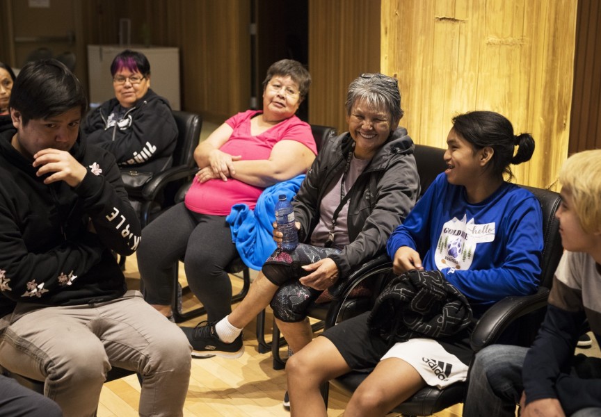 Brenda Johnson (centre) laughs with the youth at the NTC Northern Region Youth Gathering inside the House of Unity, in Tsa'xana, near Gold River, on March 29, 2022.