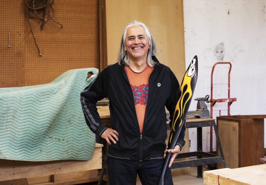 Rodney Sayers, a Nuu-chah-nulth artist from the Hupačasath First Nation, poses with a sample of his work in his Port Alberni studio on Oct. 4. (Melissa Renwick photo)