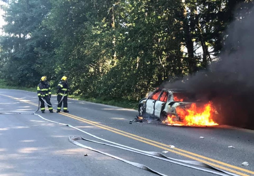Firemen attend to a vehicle blaze on Franklin River Road on July 5. 