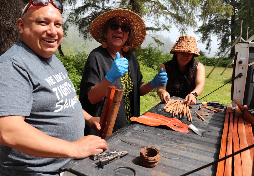 Stephen Smith, Charlene Nookemus and Mel Edwards put salmon on cedar sticks for a traditional barbecue.