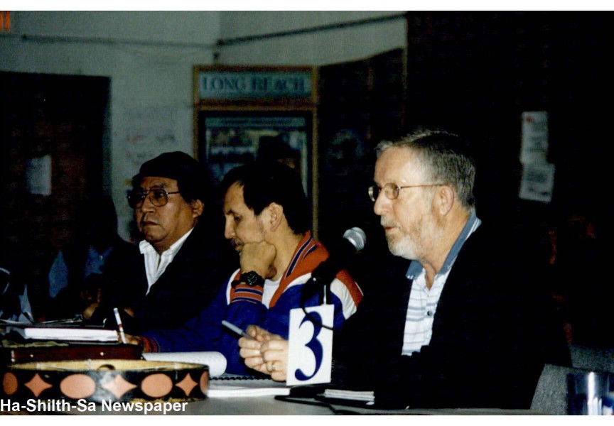 Vic Pearson speaks at a meeting, next to Archie Little (far left) and Richard Watts. 