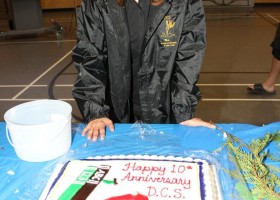 Jolene Joe helps display the 10 anniversary cake.