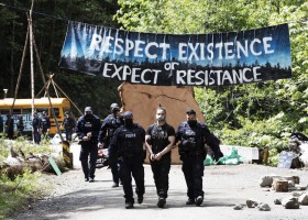 A protestor is arrested at the Caycuse old-growth logging blockade established by the Rainforest Flying Squad, near Port Renfrew, on May 19, 2021.